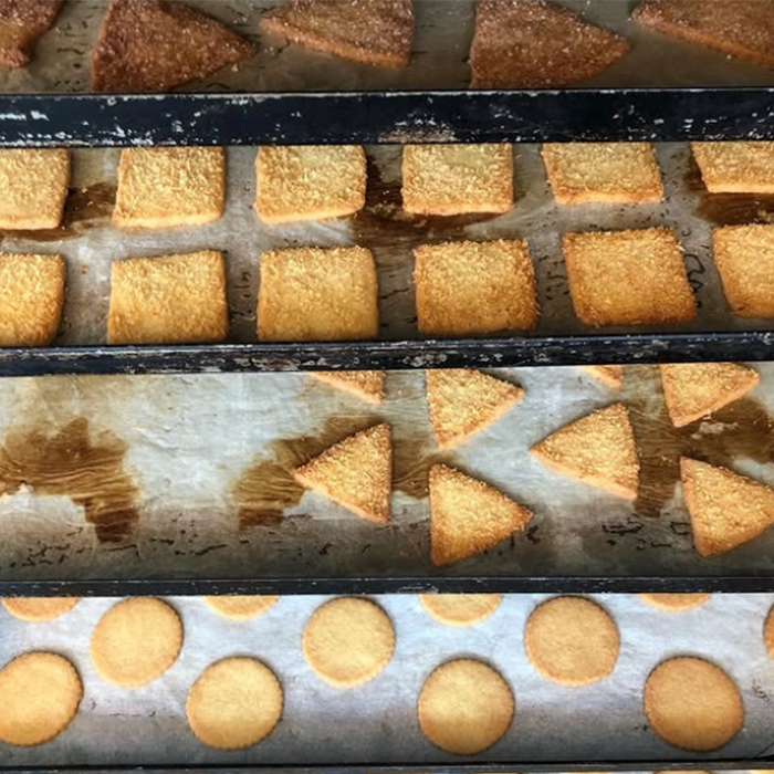 Versgebakken roomboterkoekjes op ovenplaten